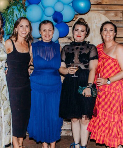 Six women wearing gowns.